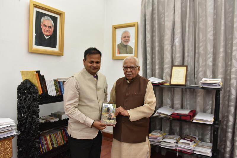 CDO Sitapur Ravindra Kumar presenting his book “Many Everests” to H.E. Governor of Uttar Pradesh Shri Ram Naik.
